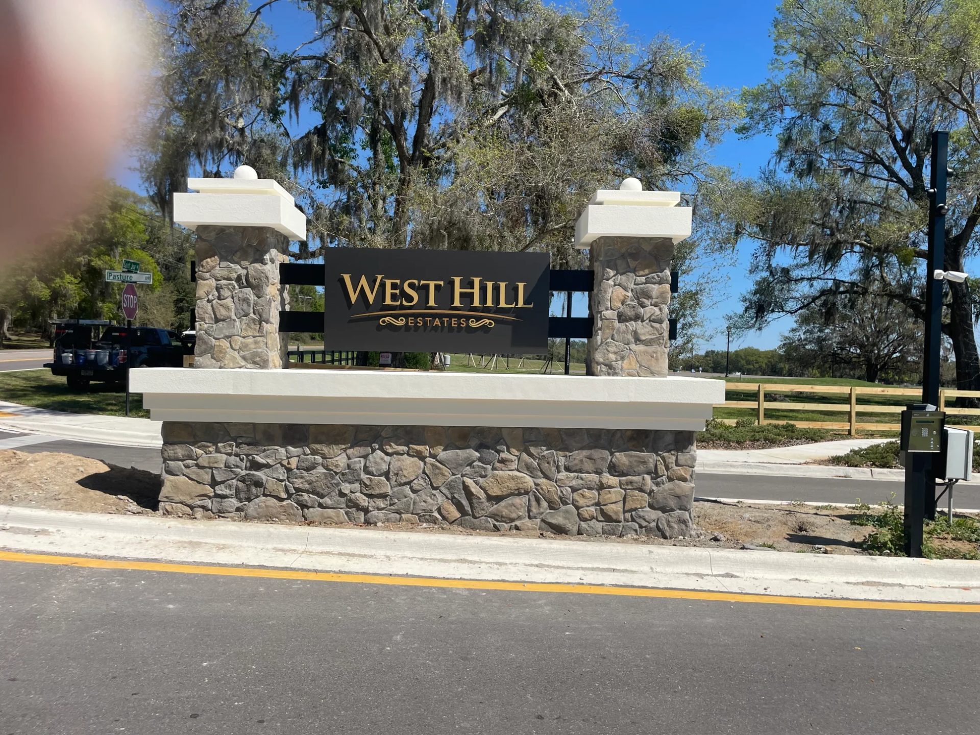 Custom stone monument sign at residential community entrance in Florida