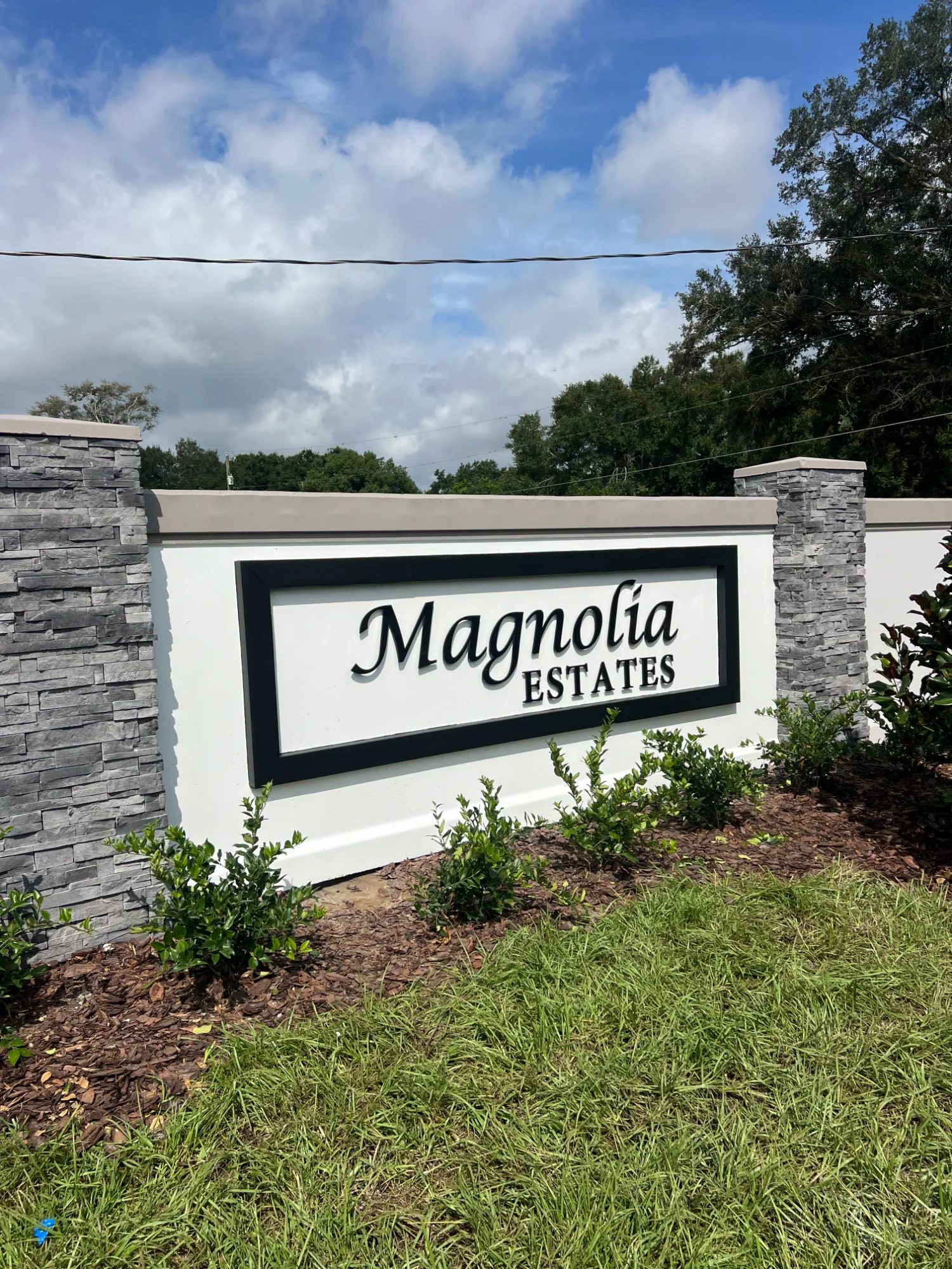 Traditional stone column precast concrete monument sign for Florida community entrance