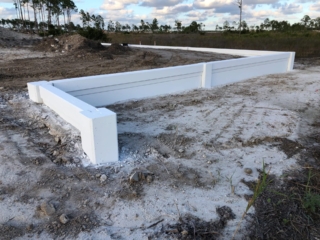 precast-concrete-retaining-wall-corner-installation White concrete wall corner installation site