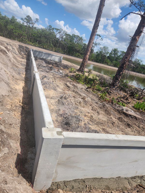Precast retaining wall installation at lakefront property Florida