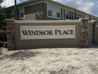 contemporary-monument-sign-windsor-place-florida Contemporary gray monument sign with stone columns for Windsor Place community Florida
