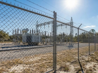 galvanized-chain-link-barbed-wire-security-florida Galvanized chain link fence with barbed wire security Florida substation security