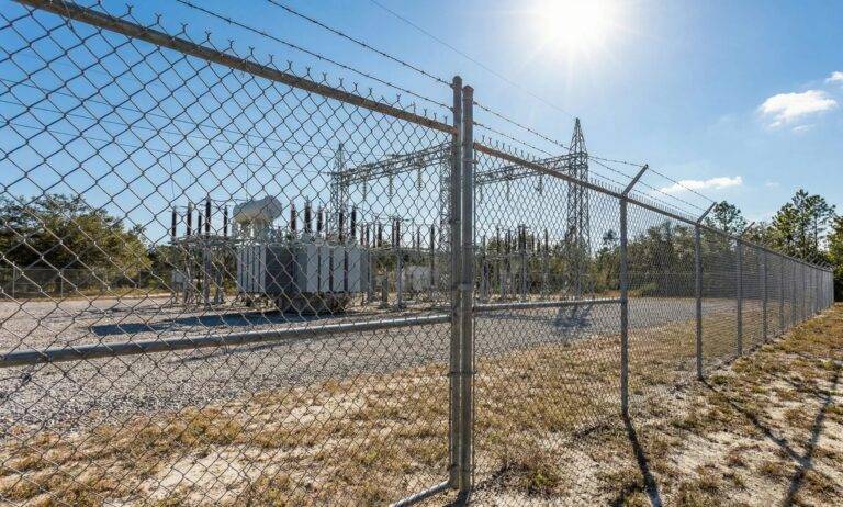 Galvanized chain link fence with barbed wire security Florida substation security
