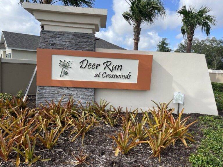 Precast monument sign with stone column and decorative graphics Deer Run Crosswinds Florida