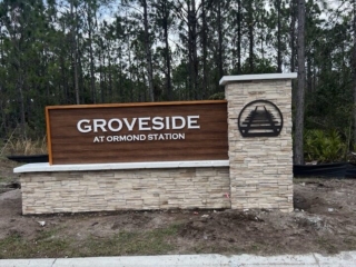 wood-panel-monument-sign-groveside-ormond-station-florida Horizontal wood panel monument sign with railroad logo Groveside Ormond Station Florida