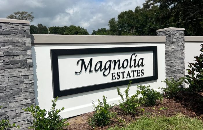 Precast concrete monument sign with decorative stone column details